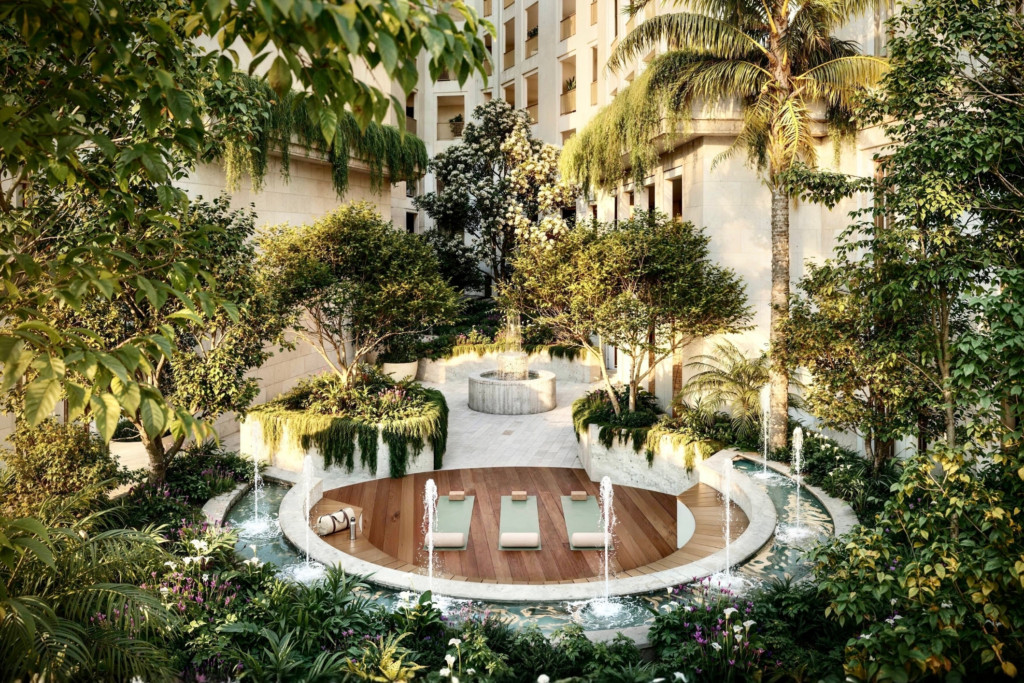 Street view of Coral Gables boutique condo neighborhood with green canopy trees and elegant architecture.