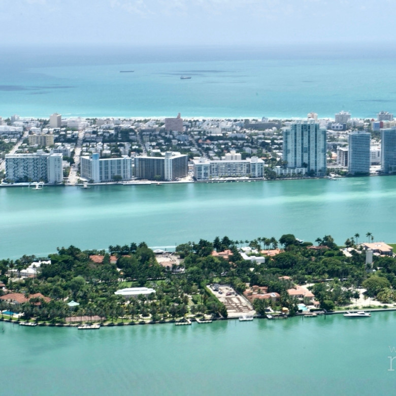 High-rise luxury towers in the South Florida housing market along the Biscayne Bay waterfront at sunset